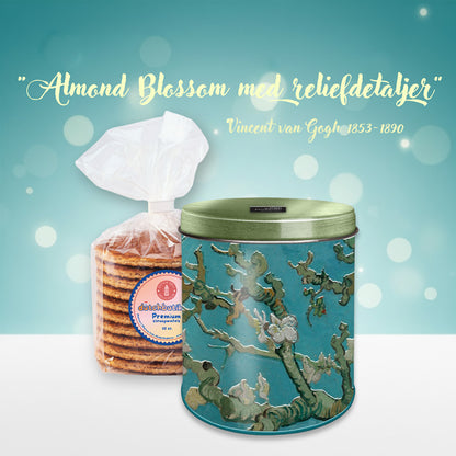 Van Gogh Almond Blossom stroopwafel-/förvaringsburk med reliefdetaljer, grönt metalliclock och ett paket premium stroopwafels från Nederländerna.