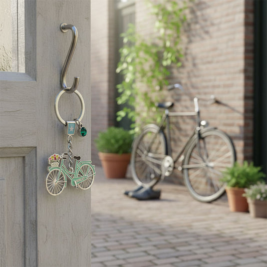Nyckelring med strassten och pastellgrön cykel med text Holland och cykelkorg med tulpaner från Matix Souvenir Holland hängt på dörren